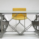 Illustration for article titled Futuristic Origami Desk Cut and Folded from a Single Sheet of Steel